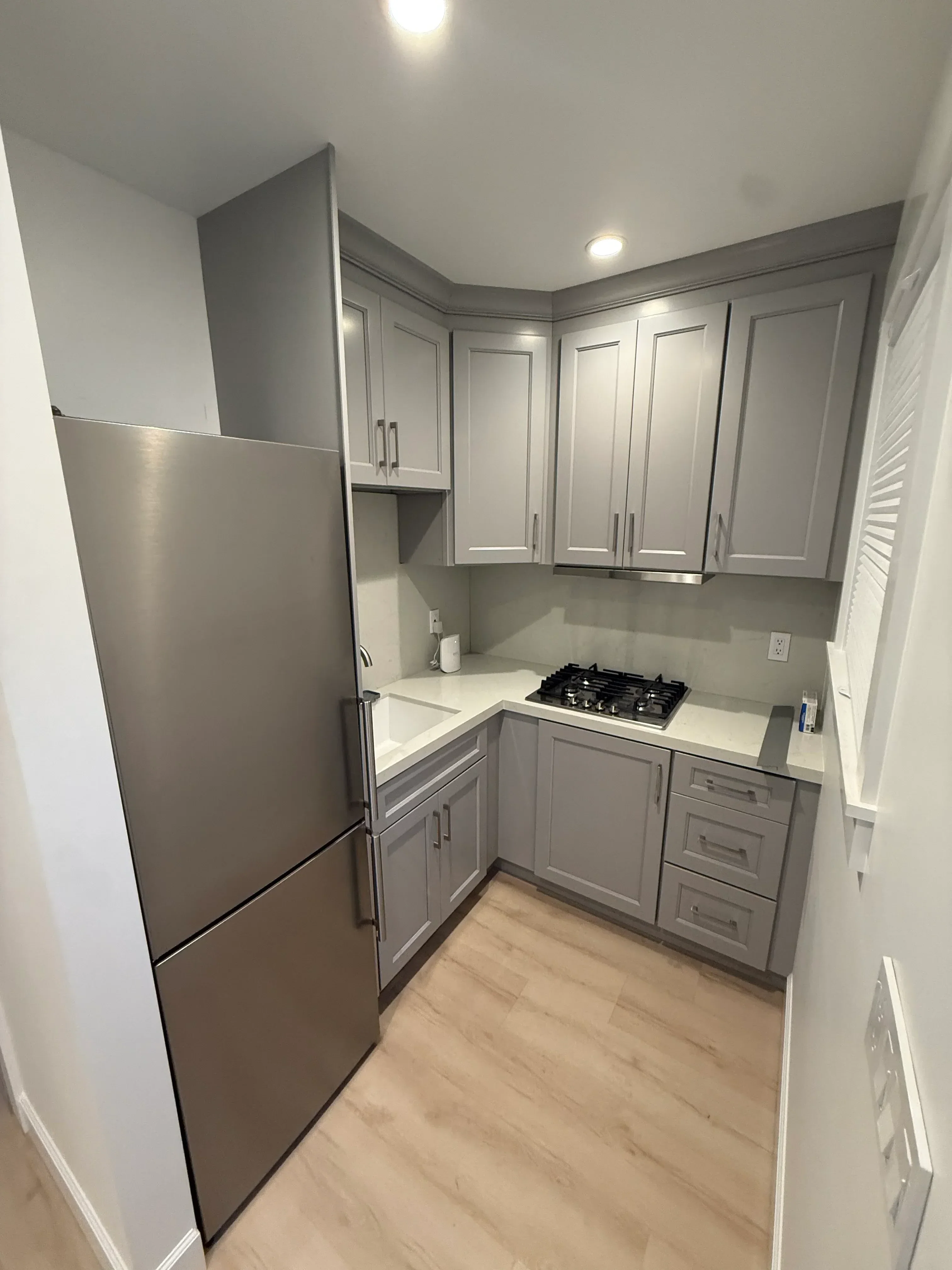RV interior with gray cabinetry, stainless steel appliances, and recessed lighting