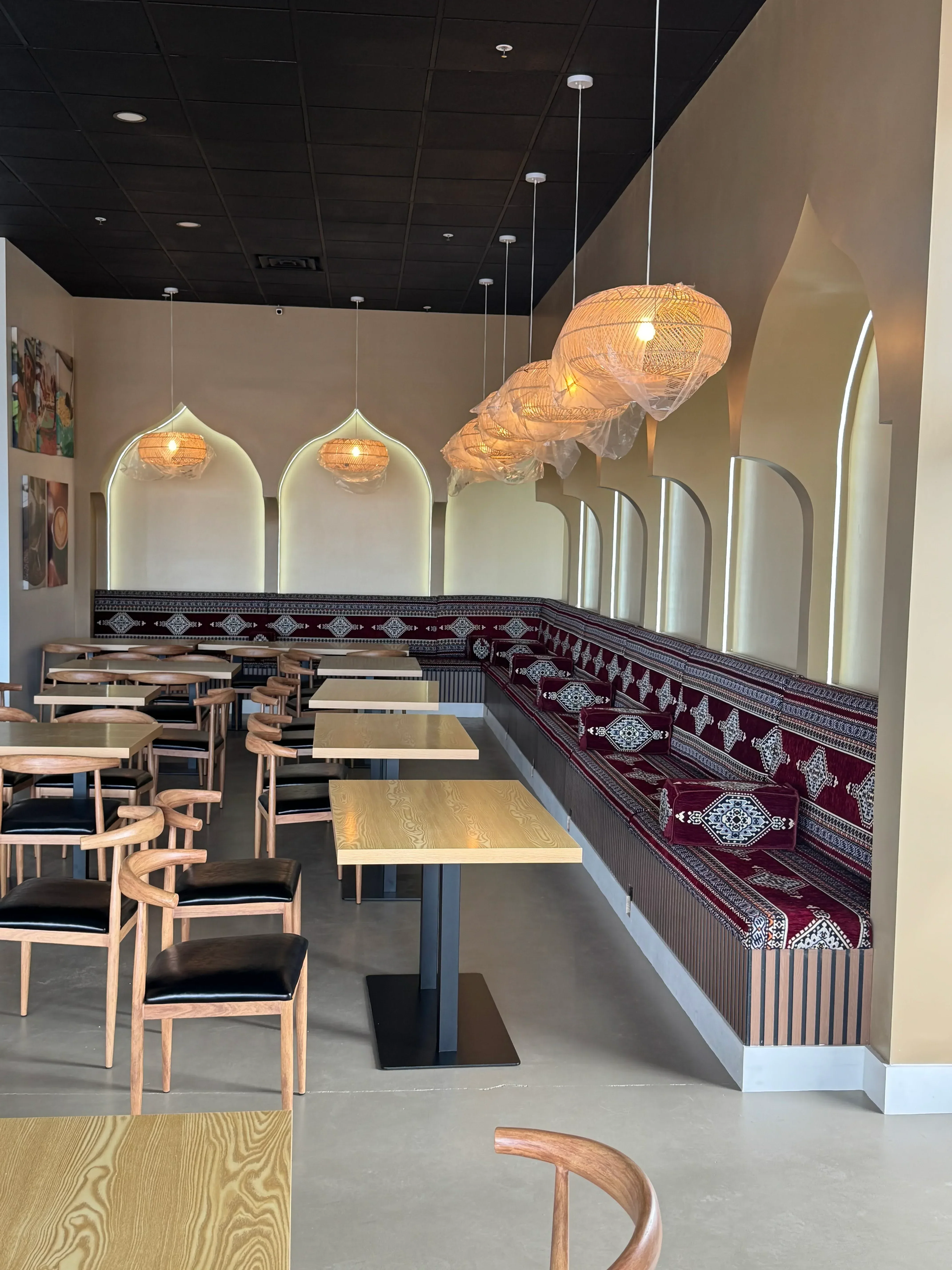 Drywall ceiling with linear LED lighting, recessed shelves, pendant fixtures, and decorative wall trim